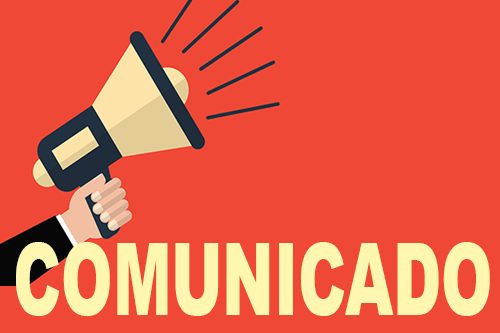 Hand holding a megaphone on a red background. Vector illustration a flat style